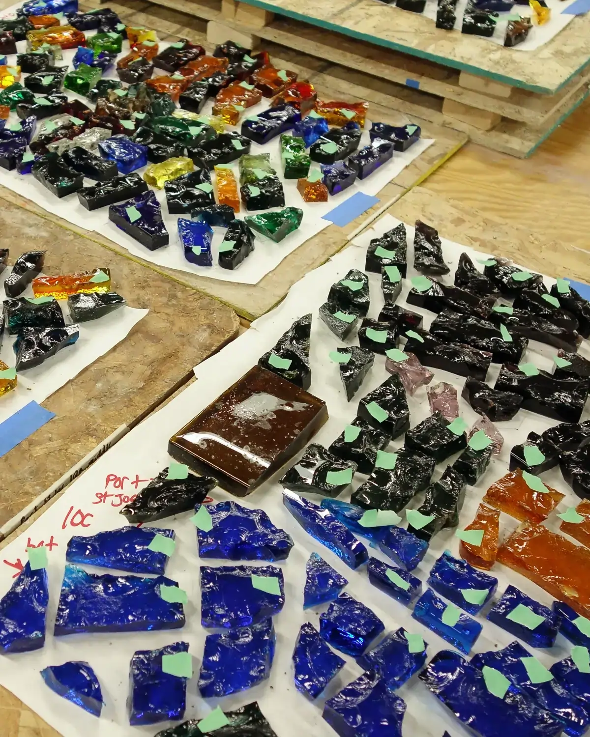 stained glass chunks on a table ready for reconstruction